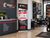 Deluxe retractable banner stand promoting a buy 3 tires get 1 free offer displayed beside the service counter in a tire store lobby