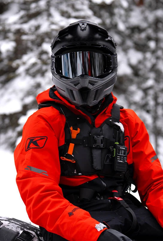 Klim snowmobile rider in orange outerwear