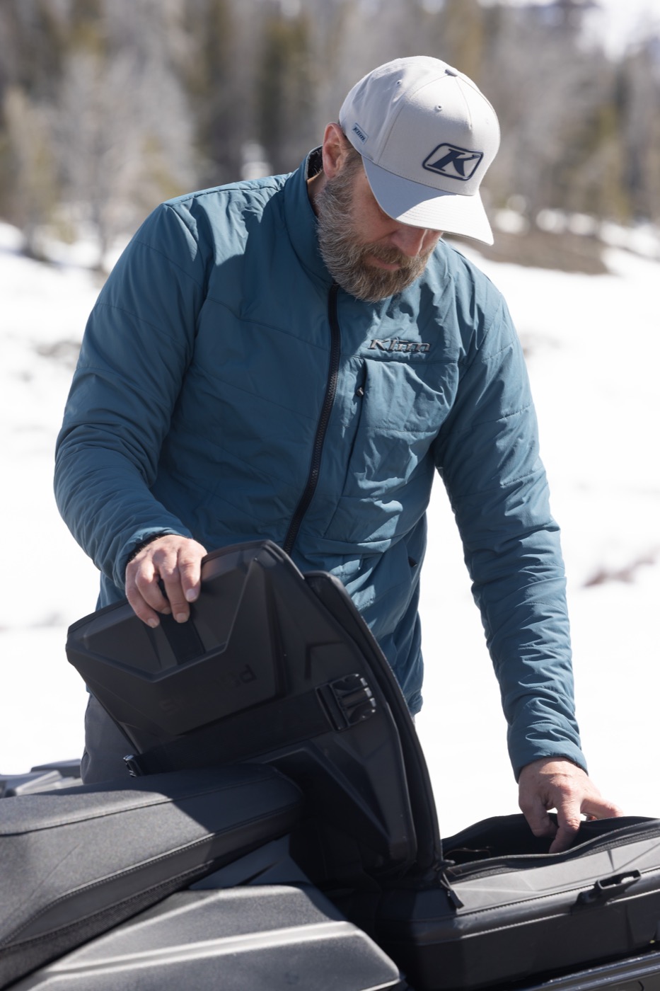 Klim insulated layering jacket at a snowy trailhead