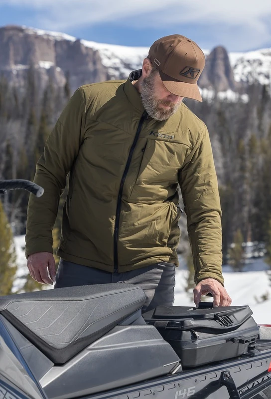 Klim insulated mid-layer jacket at a snowy trailhead