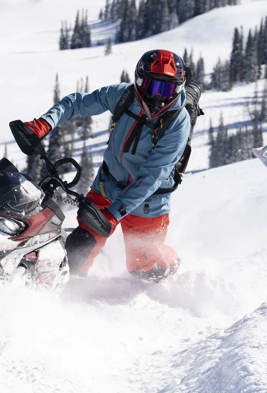 509 rider wearing blue and orange snowmobile outerwear