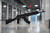 TWS Dog Leg Rail mounted on a rifle in a long industrial hallway.
