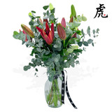 Hand-tied bouquet with red oriental lilies and eucalyptus greenery. Hand-tied bouquet with red oriental lilies and eucalyptus greenery.