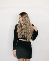 Model Wearing Rooted Ashy Blonde and Dark Dimensional Cookie Dough Hair Extensions