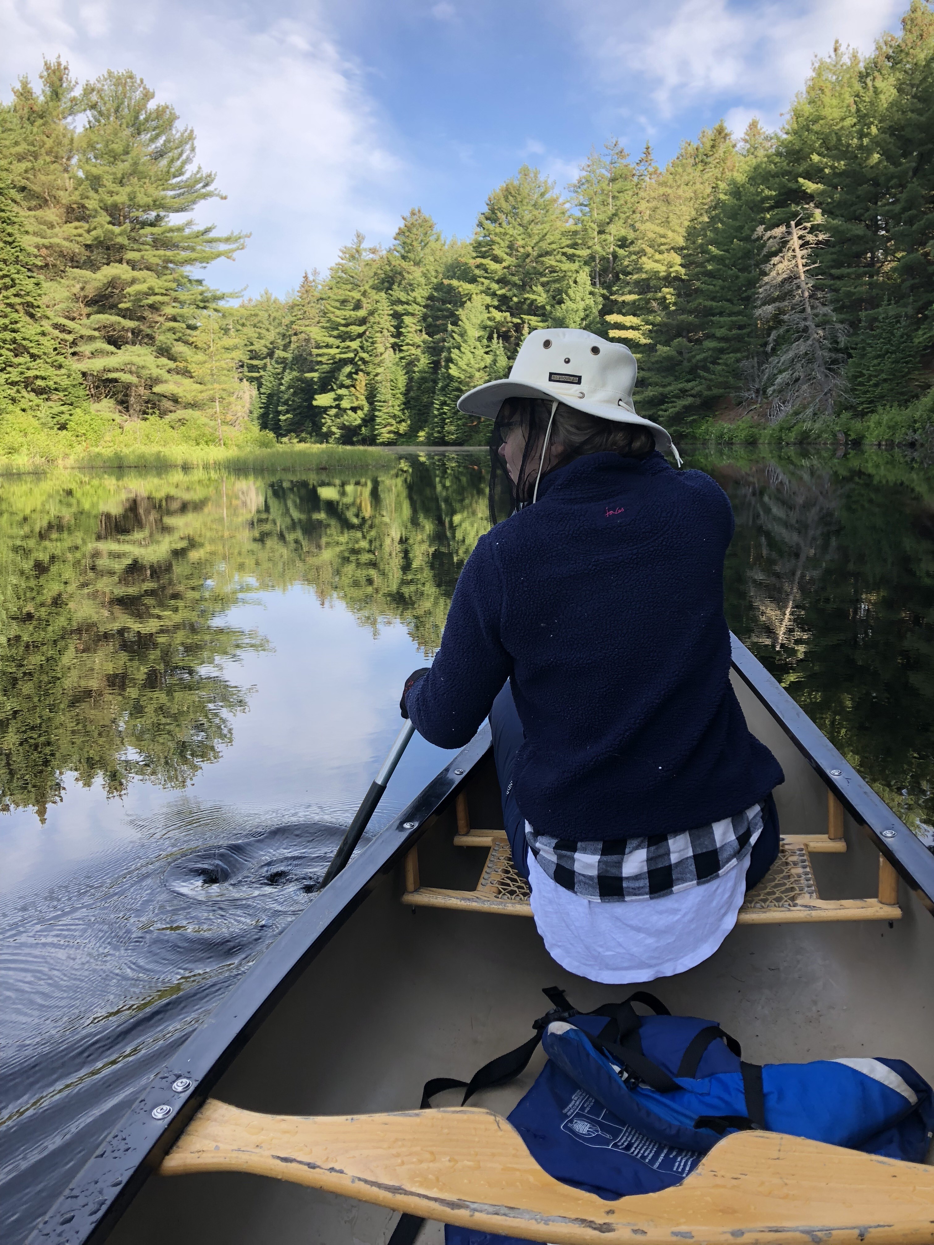 Sam and Rachel of Chinook Outfitters portaging a canoe in Algonquin Provincial Park