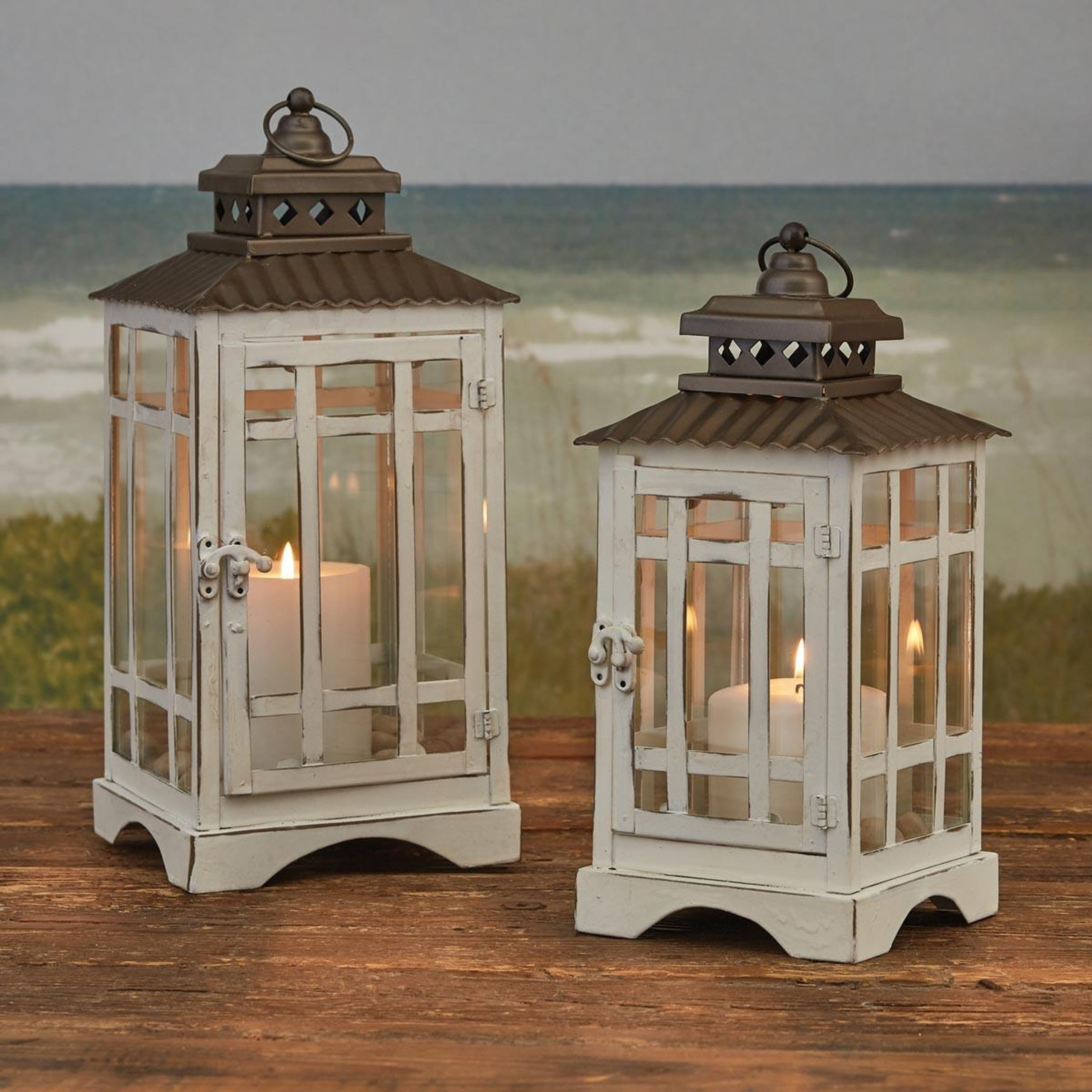 Two rustic white lanterns on a table