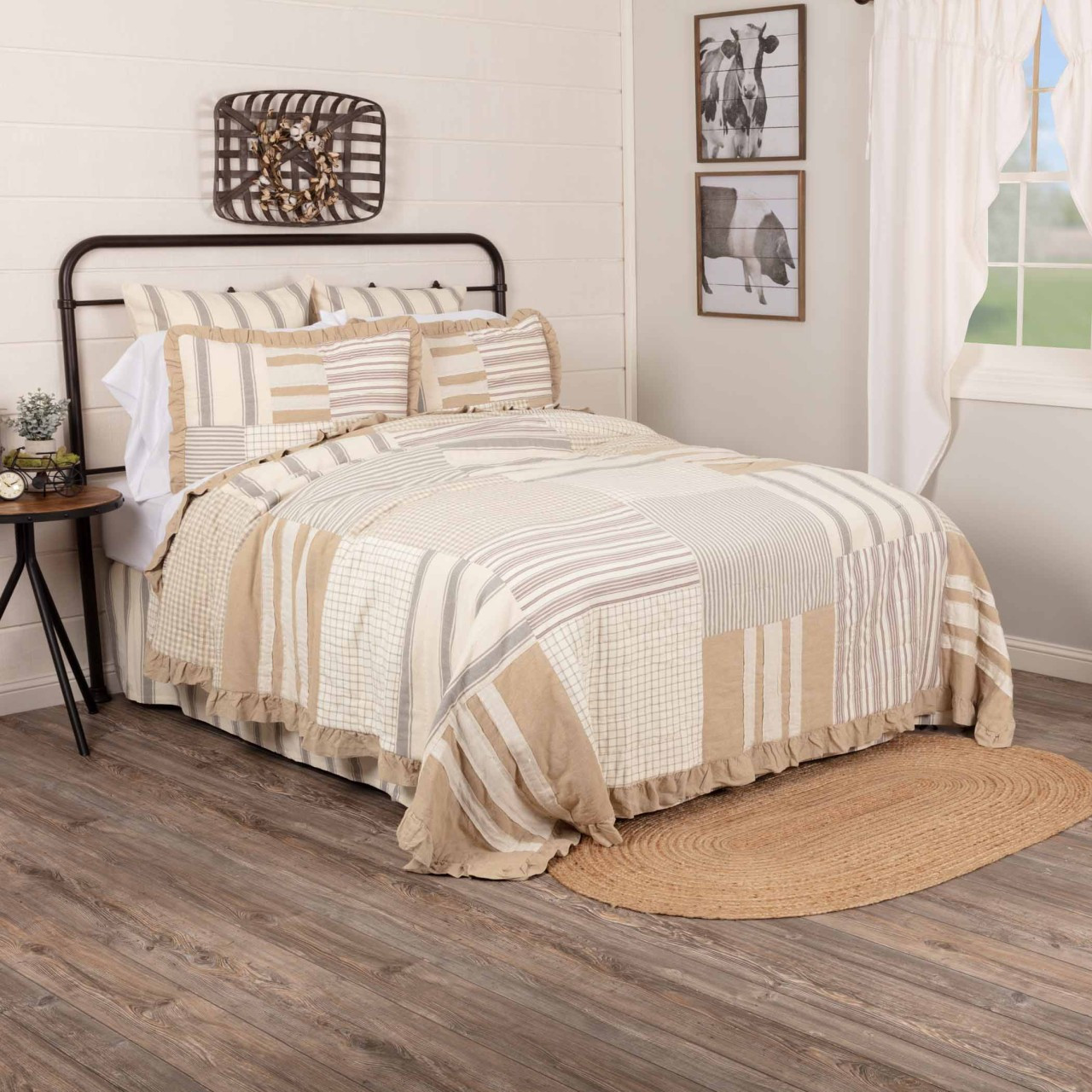 Metal bed styled with light tan patchwork bedding