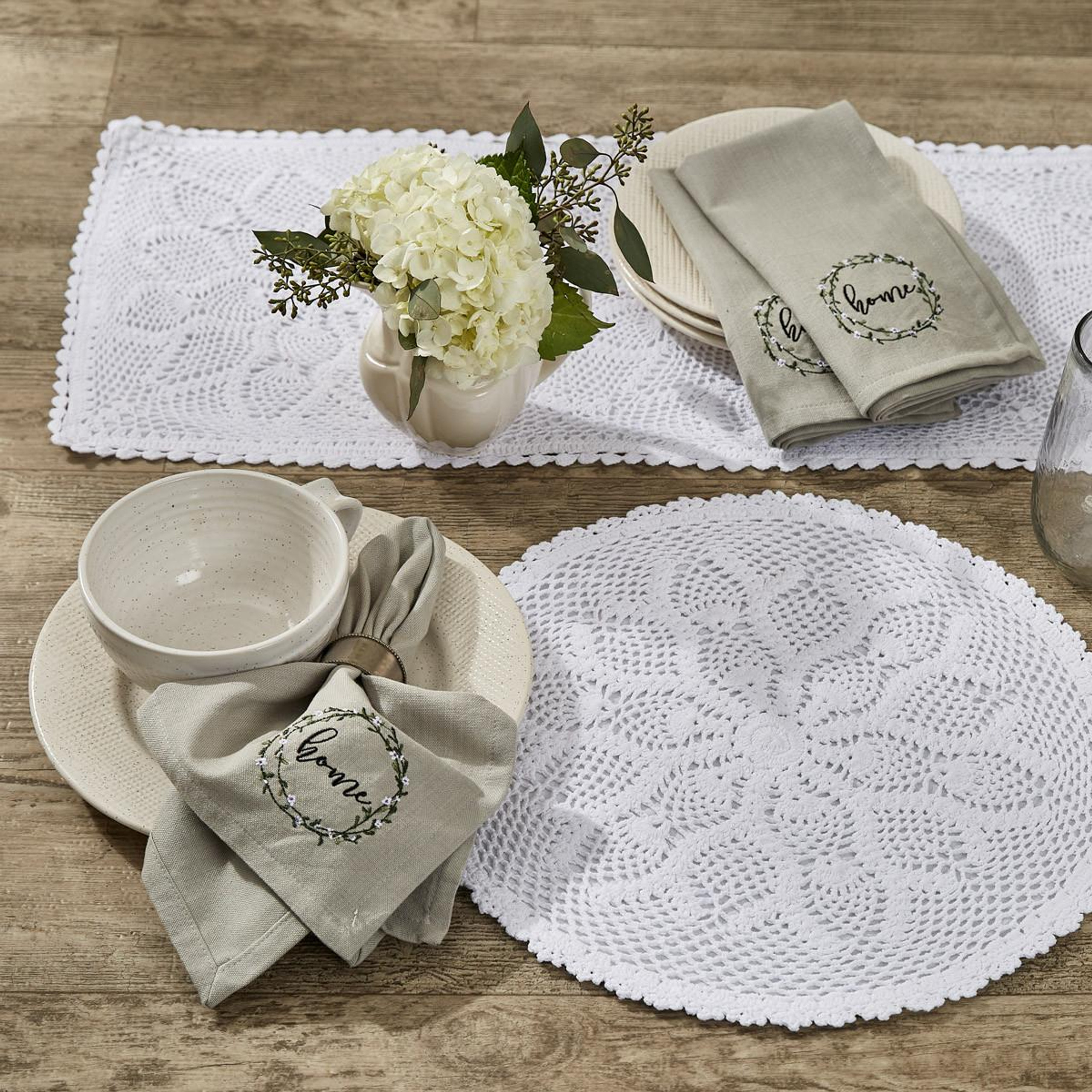 Lace table linens and plates set on a table