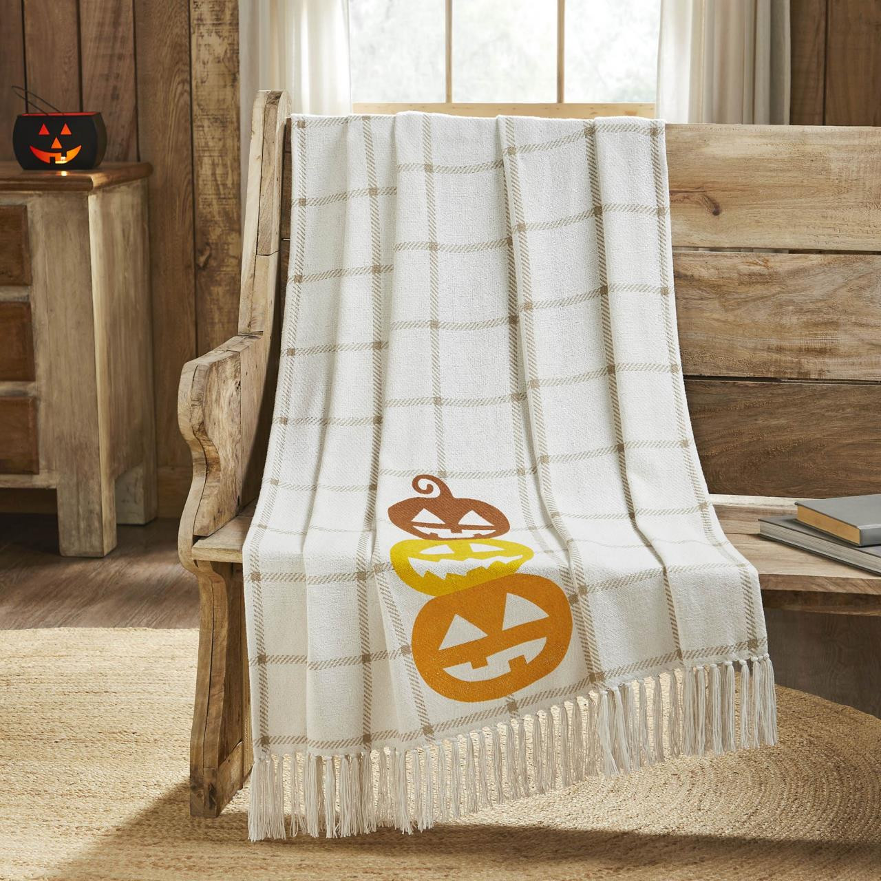 White checked throw with grinning Jack O Lanterns