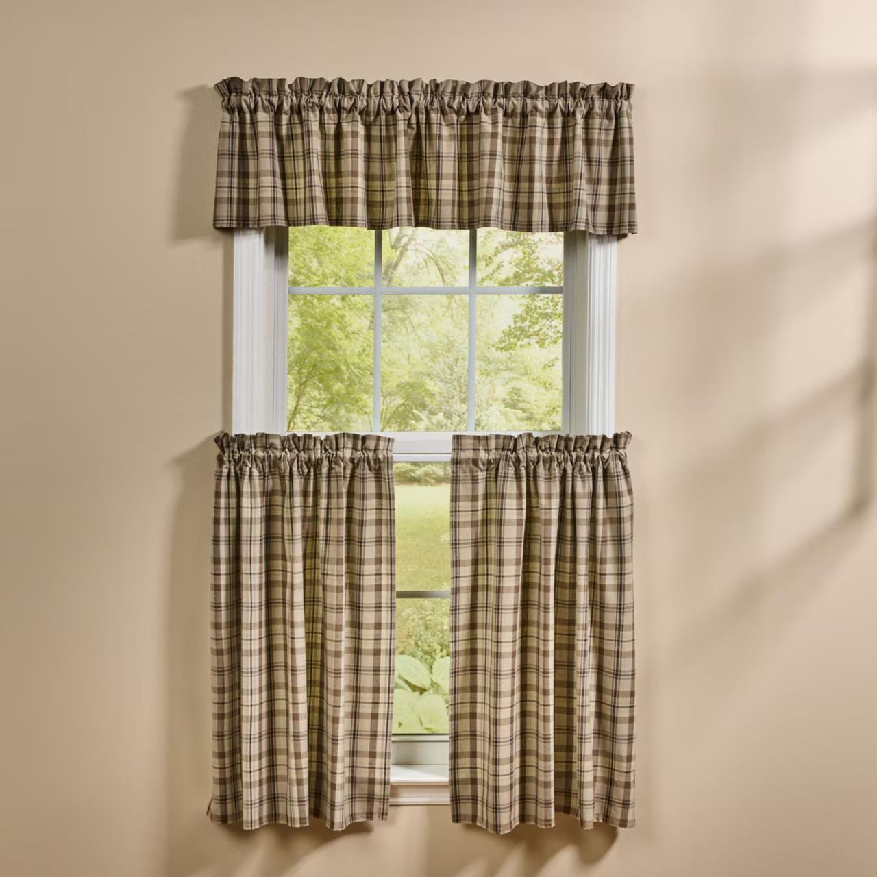 Brown plaid valance and tier curtains on a window