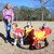 four seat infant carousel in red and yellow with kids