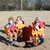 four seat infant carousel in red and yellow with kids
