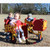 four seat infant carousel in red and yellow with kids