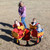 four seat infant carousel in red and yellow with kids