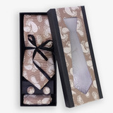 Light Brown Tie Featuring Floral Patterns