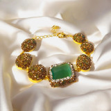 Luxury Adjustable Gold-Tone Bracelet Featuring Green Gemstone with Sparkling Crystals