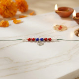 Divine Om Charm Rakhi with Red & Blue Beads