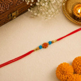 Minimalist Floral Rakhi with Blue Beads & Red Thread RT-1149