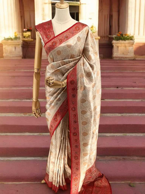 Off White Kanjivaram Silk Saree with Red Border accented with tassels