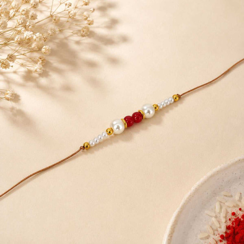 Elegant Pearl Rakhi with Red Beads & Golden Accents RK-26