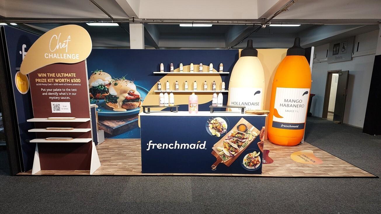 Front view of Frenchmaid trade show stand with sampling counter and product display