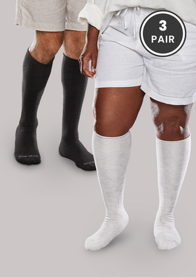 Woman and man wearing White SmartKnit Seamless Diabetic Over-the-Calf Socks - 3 Pair in [White, Black, White]