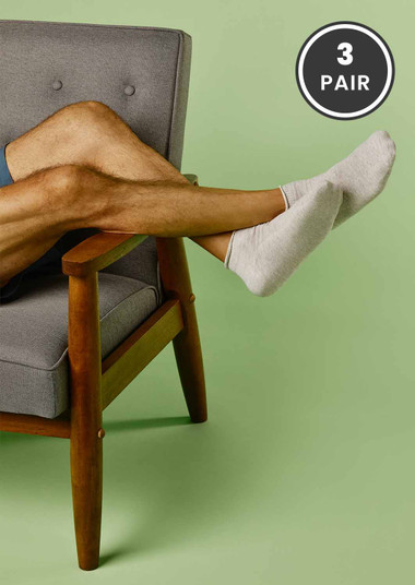 Man relaxing, wearing grey SmartKnit Diabetic Mini Crew Socks