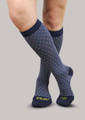 Woman wearing 20-30mmHg Ease Bold Moderate Starry Night Support Socks