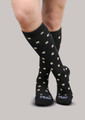 Woman wearing 20-30mmHg Ease Bold Moderate Daisy Support Socks in [Daisy]