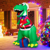 Outdoor inflatable Christmas decoration glowing with bright multicolor LED lights at night, illuminating snow,covered lawn with vivid red, green, and blue hues.