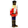 Life-size lighted nutcracker standing on a holiday front porch next to a Christmas wreath and garland