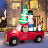 Close-up view of inflatable Santa Claus smiling while driving a festive Christmas car, with detailed multicolor design and LED illumination.