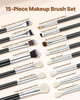 Top view of full 15-piece vegan makeup brush set with wooden handles and soft synthetic bristles on a white marble surface