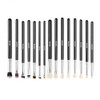 15 professional makeup brushes styled with eyeshadow palette, loose powder, and lipstick for complete beauty setup