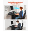 Woman working remotely at ergonomic desk with laptop on raised monitor riser and USB charging nearby Woman working remotely at ergonomic desk with laptop on raised monitor riser and USB charging nearby