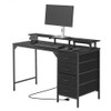 Compact black office desk with built-in storage and power strip in a minimalist home office setup Compact black office desk with built-in storage and power strip in a minimalist home office setup