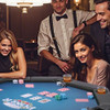 Friends enjoying poker night around foldable 8-player poker table with chips and drinks in cup holders