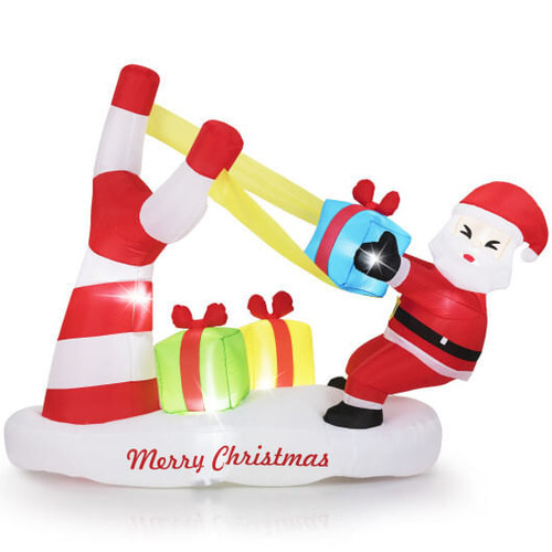 7-foot inflatable Santa with slingshot outdoor Christmas decoration displayed on a snowy front lawn during the day, featuring bright red outfit and festive design.