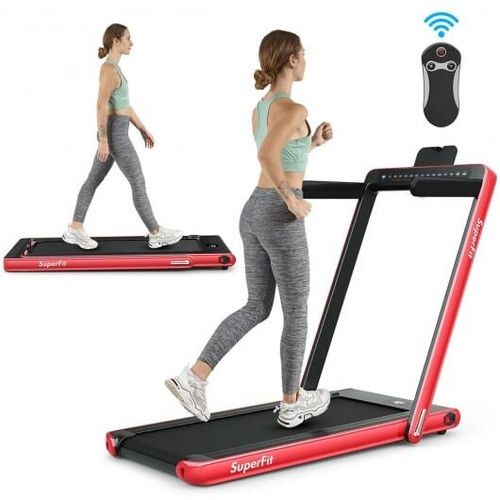 Red 2‑in‑1 folding treadmill in under‑desk walking mode beneath a home office desk, displaying dual screens and compact design.
