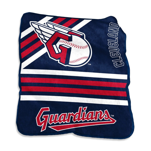 Official Cleveland Guardians 50x60 Raschel Throw Blanket draped over a leather couch, showcasing bold team logo and vivid red, white, and navy colors — perfect for fan caves, game day lounging, or MLB gift ideas.
