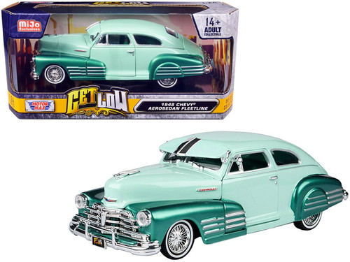 1948 Chevrolet Aerosedan Fleetside Lowrider 1/24 diecast model by Motormax in pastel green and metallic green two-tone finish, featuring chrome accents, whitewall tires, and fully opening doors, hood, and trunk, displayed on a collector’s shelf in window box packaging.