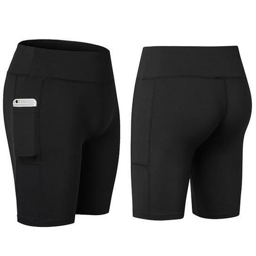 Woman wearing black stretchable yoga shorts with a high waistband, confidently posing outdoors. A smartphone is securely tucked into the side pocket, showcasing the shorts' functional design and body-hugging fit perfect for workouts or casual wear.