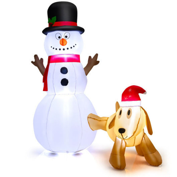 6 foot tall inflatable snowman and dog yard decoration standing in front lawn during daytime, unlit with bright white fabric and holiday accessories