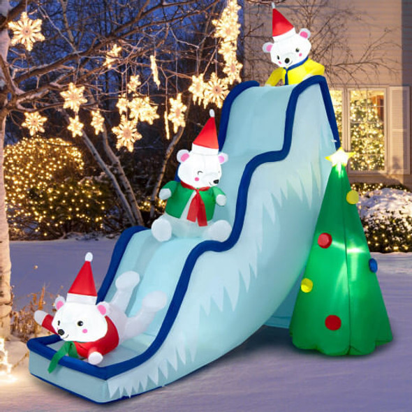 Large 9 feet Polar Bear Slide Inflatable fully inflated on green lawn during daytime, durable weather-resistant Christmas decoration for family,friendly holiday yard setup.