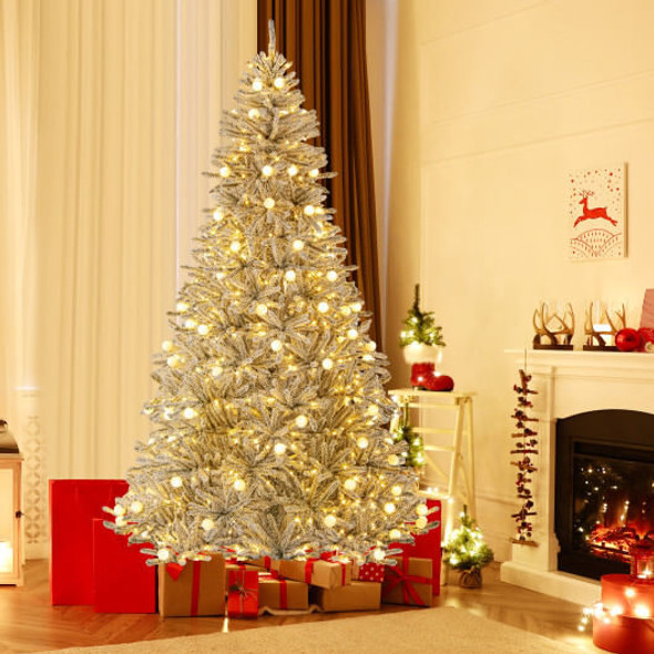 Detailed view of glowing sphere-style LED lights nestled within realistic snow-covered branches of pre-lit Christmas tree