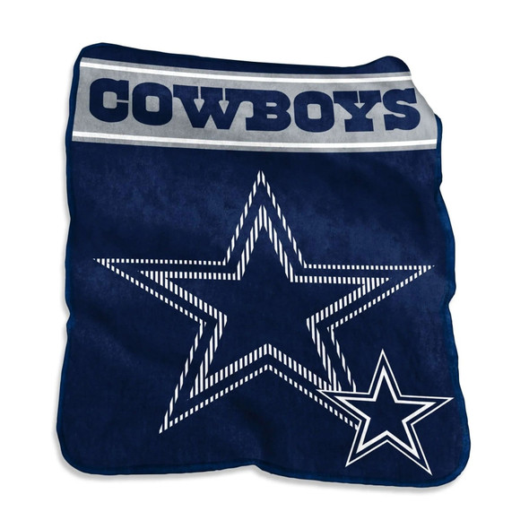 Smiling fan relaxing on a couch wrapped in a large 60x80 Dallas Cowboys Raschel Throw Blanket featuring bold navy blue and silver team logo, showcasing the ultra-soft texture and oversized comfort of the officially licensed NFL product. Smiling fan relaxing on a couch wrapped in a large 60x80 Dallas Cowboys Raschel Throw Blanket featuring bold navy blue and silver team logo, showcasing the ultra-soft texture and oversized comfort of the officially licensed NFL product.