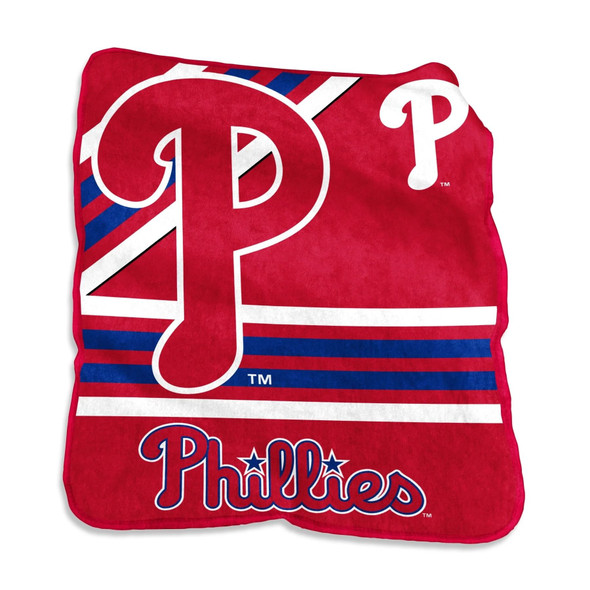 Official Philadelphia Phillies Raschel Throw Blanket folded on a couch with bold red team logo and soft fleece texture visible Official Philadelphia Phillies Raschel Throw Blanket folded on a couch with bold red team logo and soft fleece texture visible
