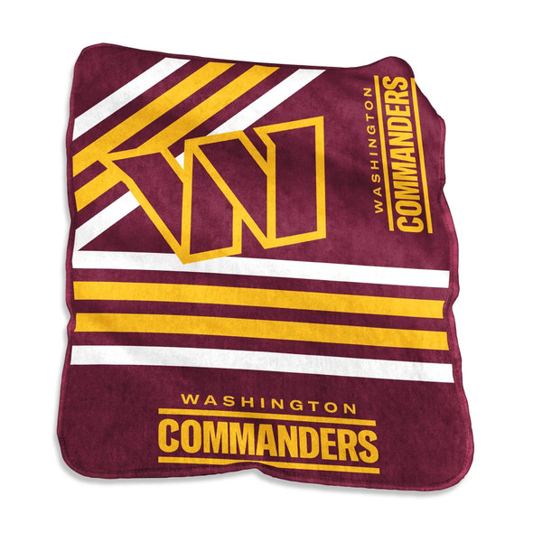 Official Washington Commanders Raschel throw blanket draped over a living room couch, showing bold team logo and vivid burgundy and gold colors on soft fleece fabric — perfect for NFL fans and game day comfort. Official Washington Commanders Raschel throw blanket draped over a living room couch, showing bold team logo and vivid burgundy and gold colors on soft fleece fabric — perfect for NFL fans and game day comfort.