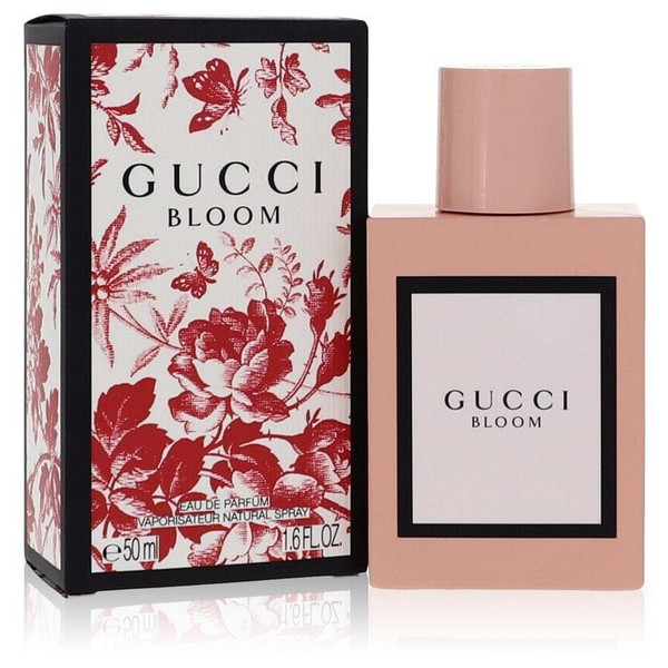 Gucci Bloom Eau De Parfum Spray 1.6 oz for women, displayed in blush-pink rectangular bottle with signature floral packaging, photographed on a white marble surface with soft natural lighting.