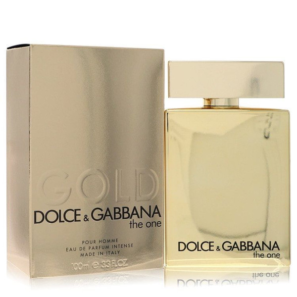 Dolce & Gabbana The One Gold Eau De Parfum Intense Spray for Men, 3.3 oz bottle, displayed upright on a sleek black marble surface with warm spotlighting emphasizing the gold finish, evoking luxury, elegance, and masculine sophistication.